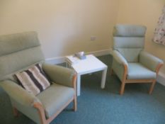 Four green cloth high back arm chairs and a small white coffee table