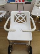 Two mobile shower chairs