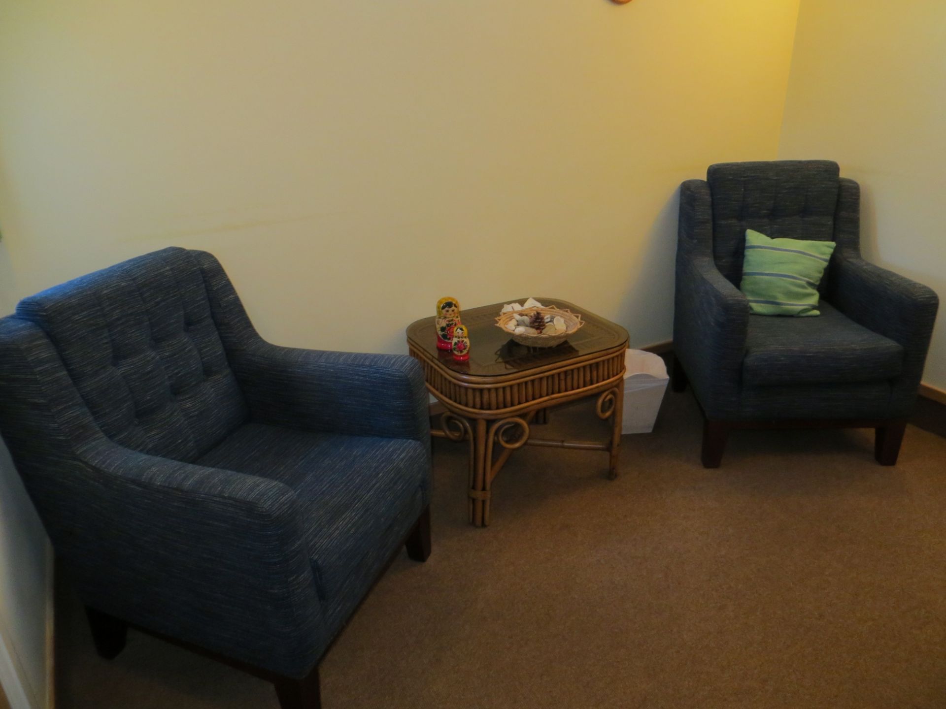 Contents of two councilling rooms to include five blue cloth armchairs, wicker glass top side table,