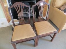 Two matching wood framed dining chairs with cloth pad seats