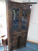 Dark wood carved corner cabinet and a drop leaf table