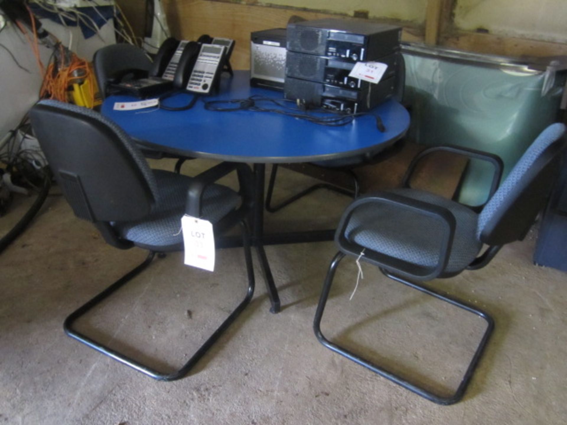 Circular meeting table with 4 x black frame upholstered meeting chairs