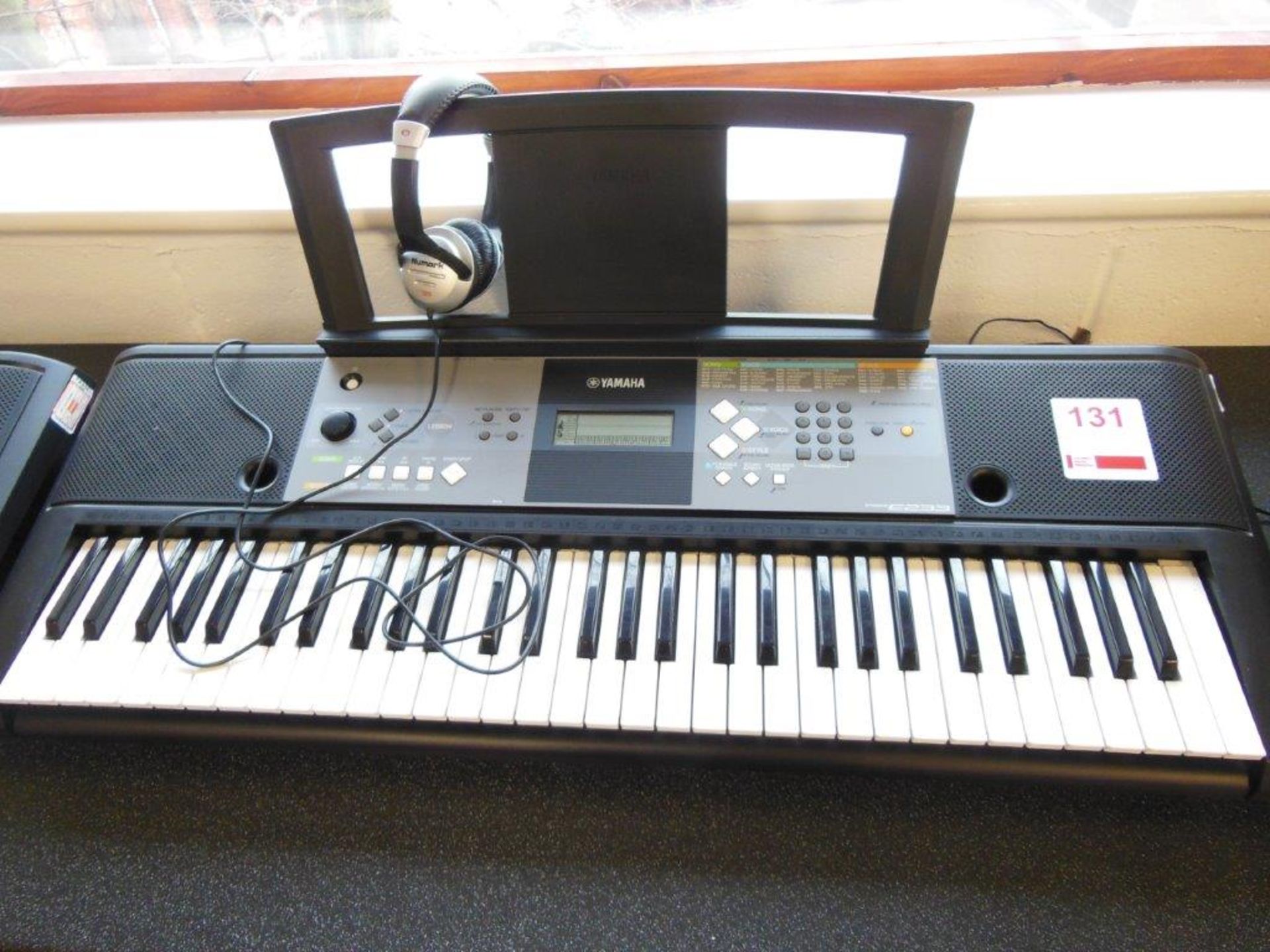 Yamaha PSR E233 electronic keyboard c/w a pair of Numark HF125 headphones. *(Lot located: