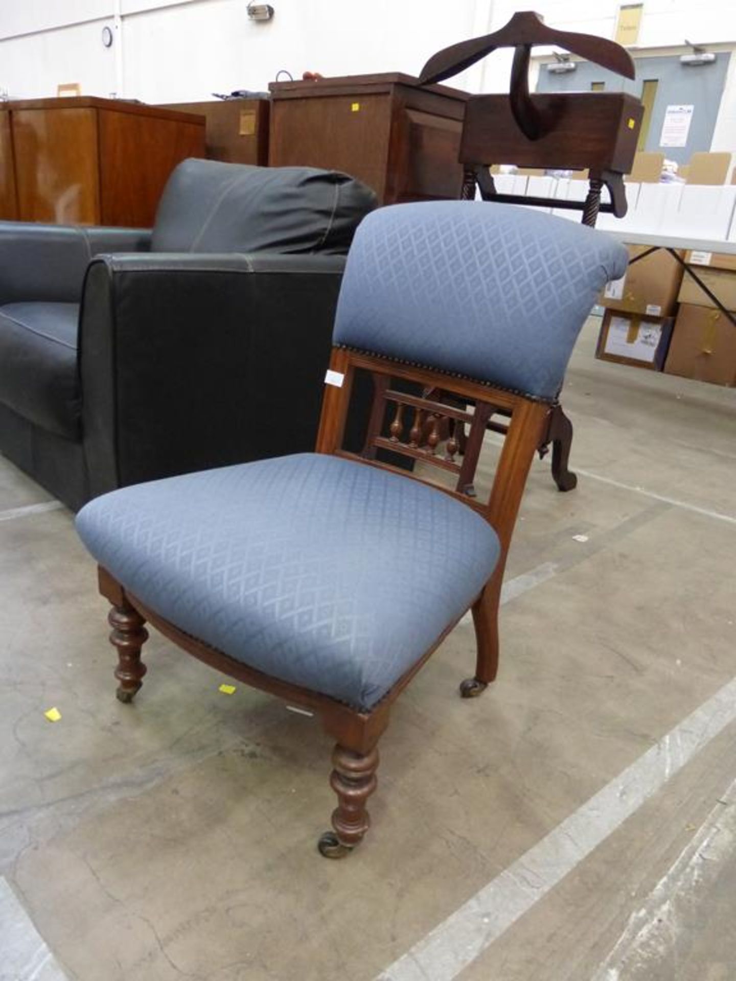 A Late Victorian Walnut Nursing Chair with upholstered back and seat on turned front legs (est £