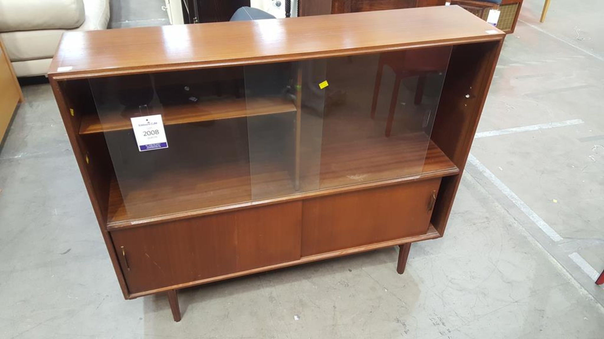 A Two Sliding Door Cabinet (H 102cm, W 122cm, D 27cm) (est £20-£30)