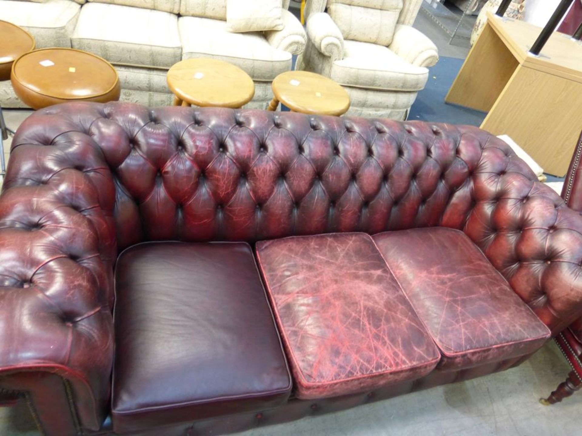 A red leather upholstered Chesterfield Three Seater Sofa (est £100-£200)