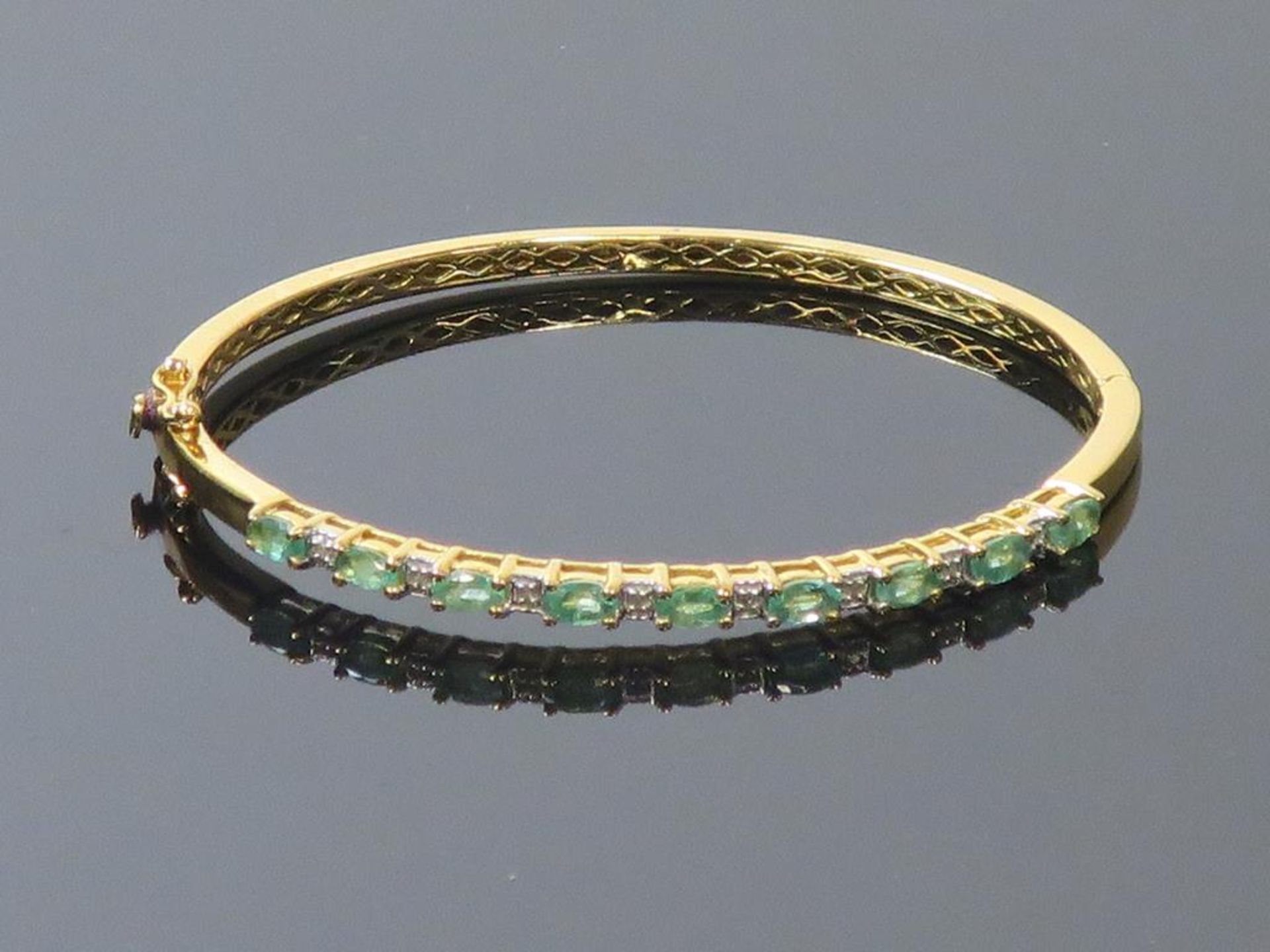 A Diamond and Emerald Set Yellow Metal Bangle marked '925' (est £70-£110)