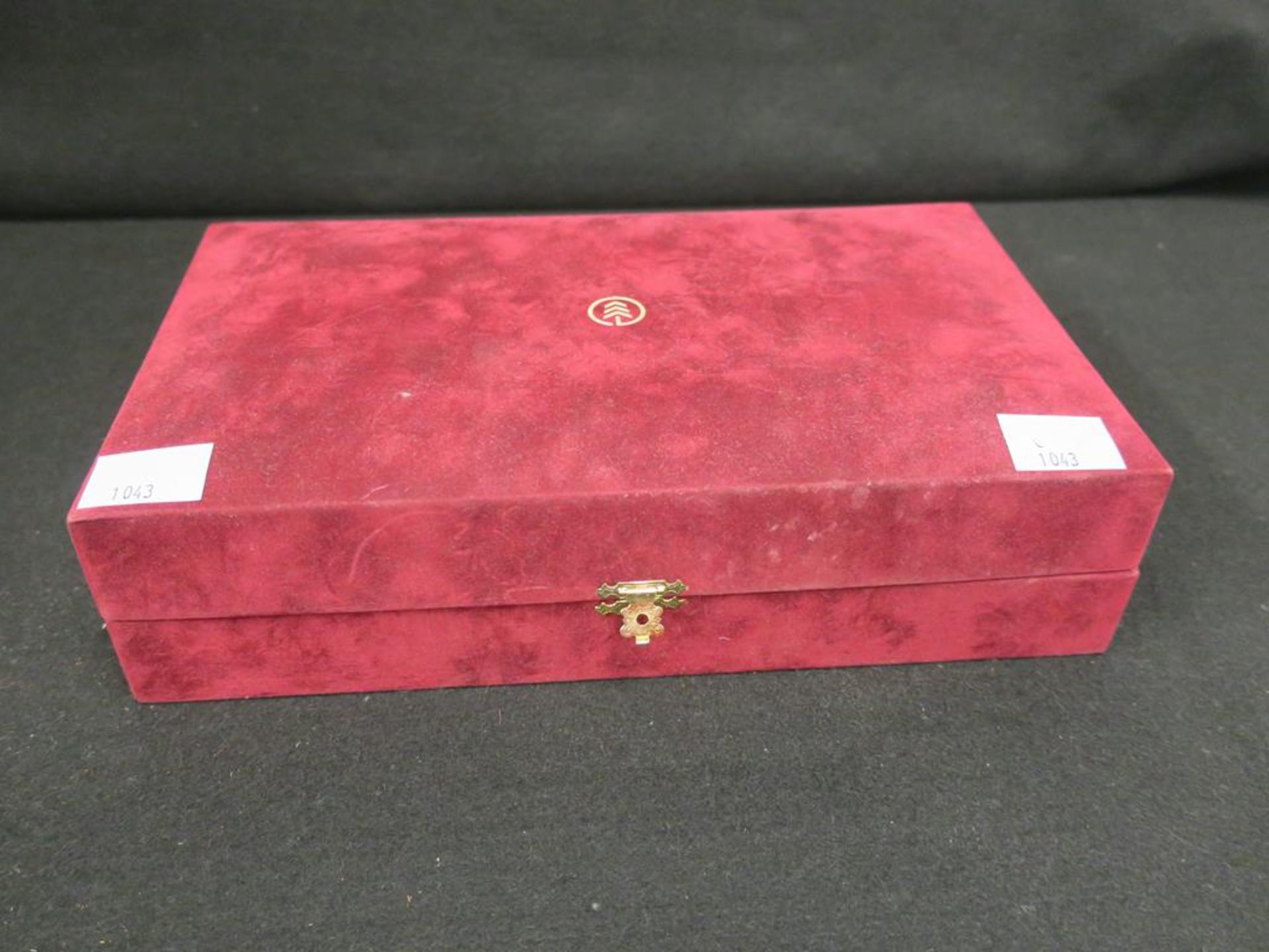 A red Jewellery box containing a quantity of vintage costume Jewellery to include Amethyst Beads and