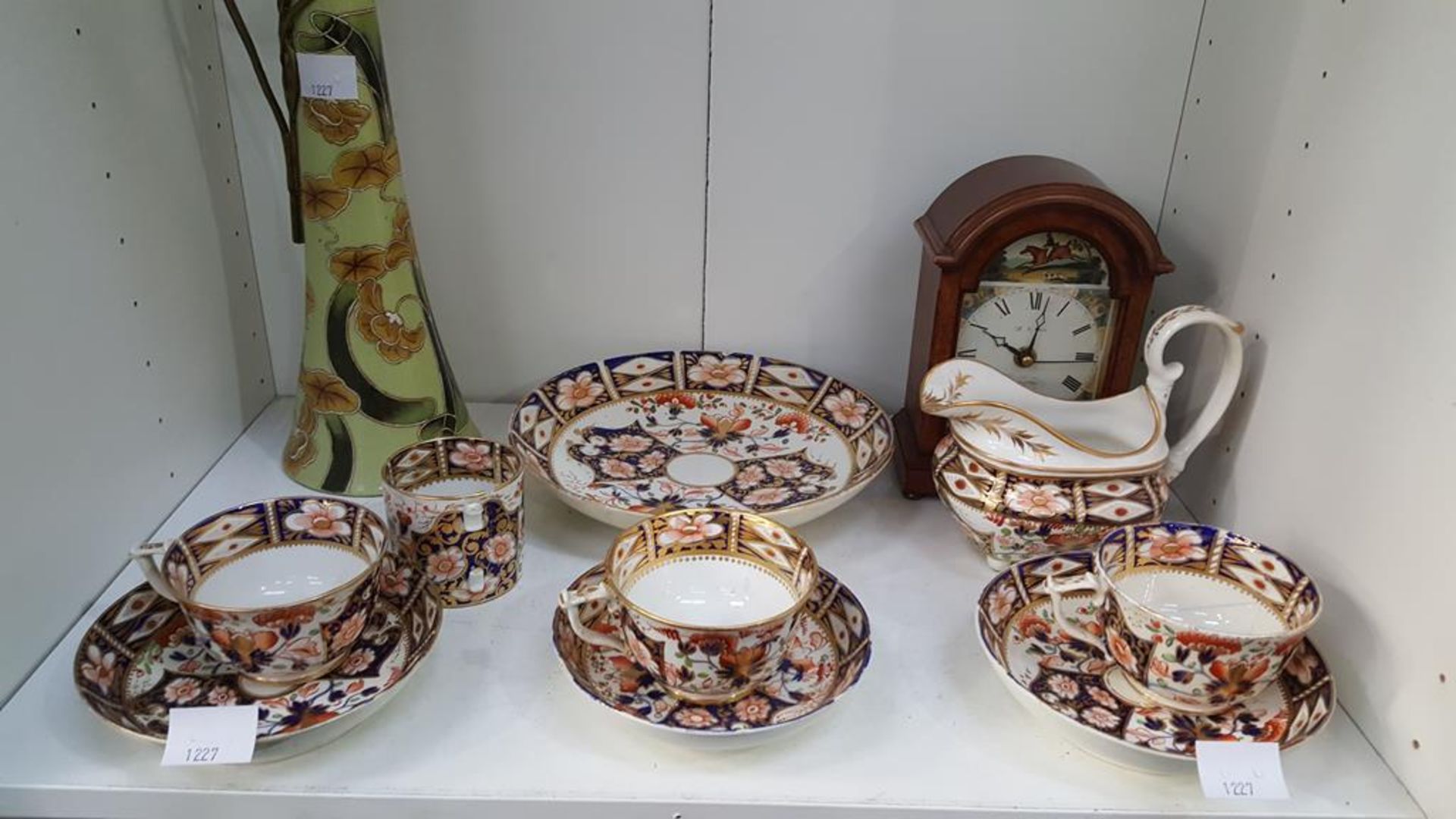 A shelf containing Royal Crown Derby Imari Style Teacups, Sauces and Milk Jug, together with a Brass