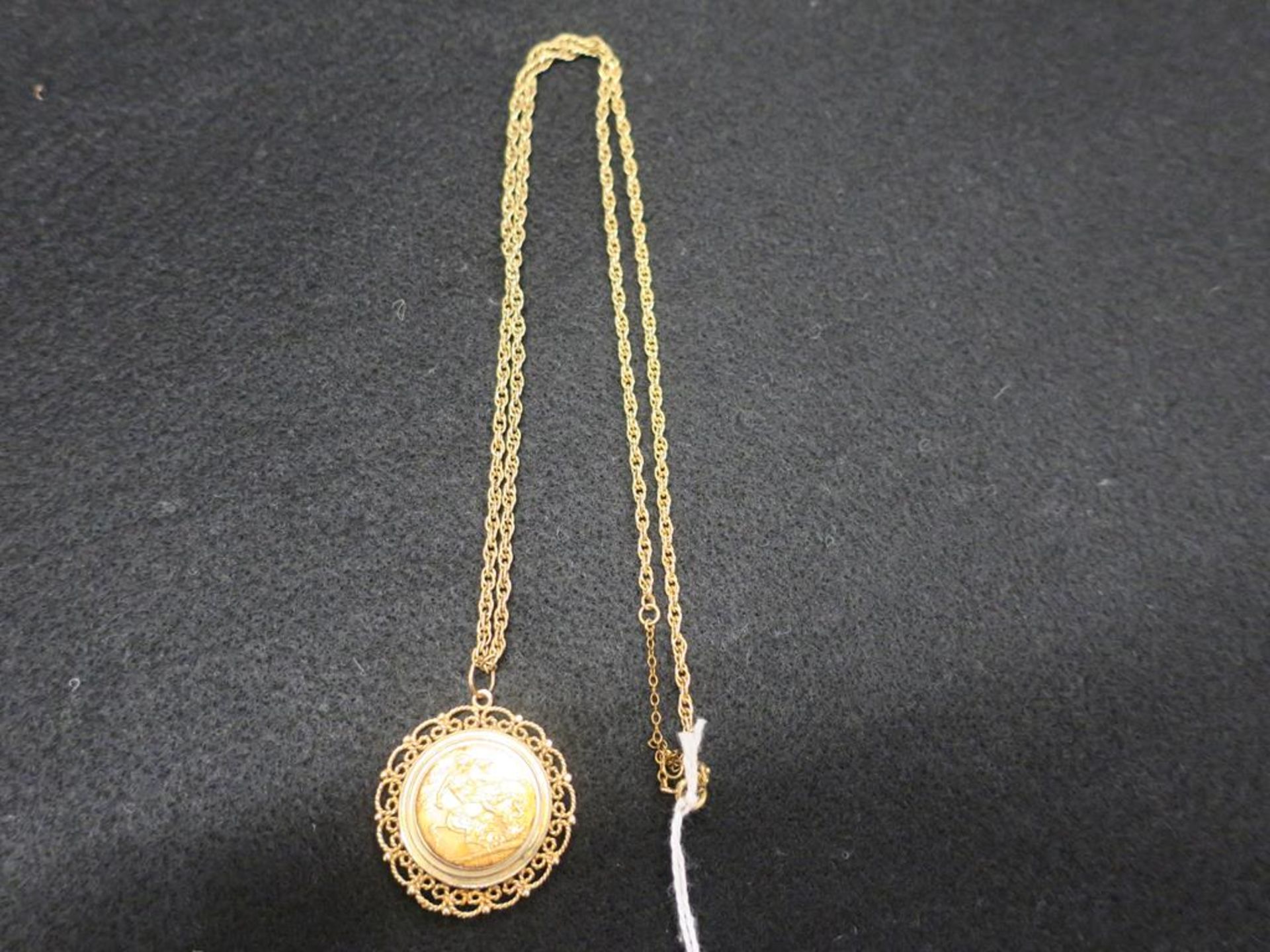 A George V 1917 Full Sovereign Loosely Mounted as a Pendant on a 9ct Gold Chain. Total Weight (