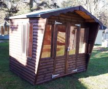 8ft x 6ft Barrel board summerhouse with felt roof and glazed windows. RRP £1,400. *Purchaser