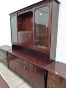 A Stag Mahogany Wall Unit with Central pull-down Writing Shelf, Flanked by glazed Doors over Drawers
