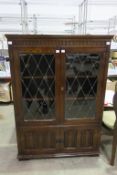 A Tall Bookcase with Glass Doors upon Two Doors (H137cm, W97cm, D31cm) (est £25-£40)