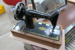 A Manual Singer Sewing Machine Number EB 405120 with cover and carry handle (est £20-£40)