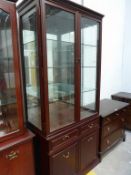 A reproduction Mahogany Tall Standing Display Cabinet with Etched Glass Doors enclosing shelves over