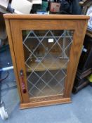 * A Small Oak Hanging Corner Display Cabinet by 'New Plan Furniture Ltd Bradford' with glazed leaded