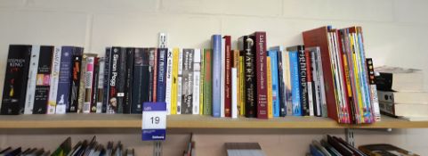 Assortment of books to shelf including literature,