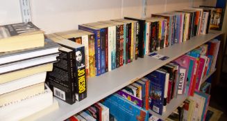 Assortment of books to shelf including literature,