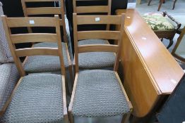 * A Teak Drop Leaf Table and Four Chairs. Each chair has a patterned, cushioned upholstered seat (