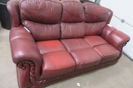 Charity Lot. A Three Seat Red Leather Settee. No estimate or reserve