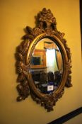 * Ornate Gilt Framed Oval Mirror. This lot is located in the Marble Room