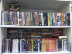 Two Shelves containing DVD's of Various Genres. Please note the buyer must bring packing materials