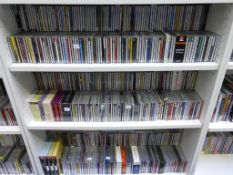 Three Shelves containing CD's of Various Genres. Please note the buyer must bring packing