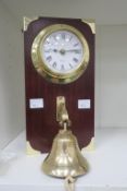A Brass 'Ships Clock' Type Timepiece with quartz movement mounted on wood above brass bell (est £