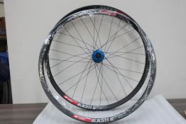 Two New DT Swiss EX 511 27.5 Rims, one of which is fitted with a Hope Pro 4 Blue Rear Hub