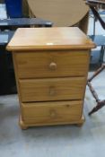 A Modern Pine Bedside Chest of three Drawers