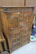 A Reproduction Oak Drinks Cabinet with carved and