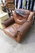 A Tan Leather Easy Armchair (est £10-£20)