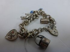 A Heavy Silver Charm Bracelet with Five Charms 73g