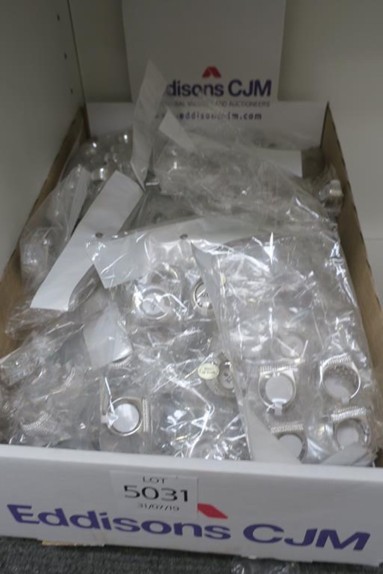 A Box containing Silver Coloured Rings of assorted styles and sizes