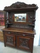 A Large Oak Dresser with Heavily Carved Panels and
