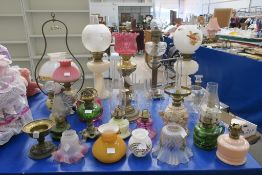 A selection of Oil Lamps, clear Glass Chimneys etc