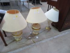A Pair of Large Table Lamps and Another Lamp