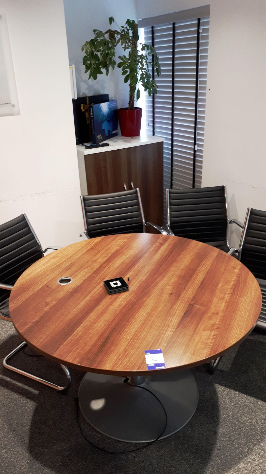 Circular light oak effect meeting table with 4 leather effect chairs and cupboard