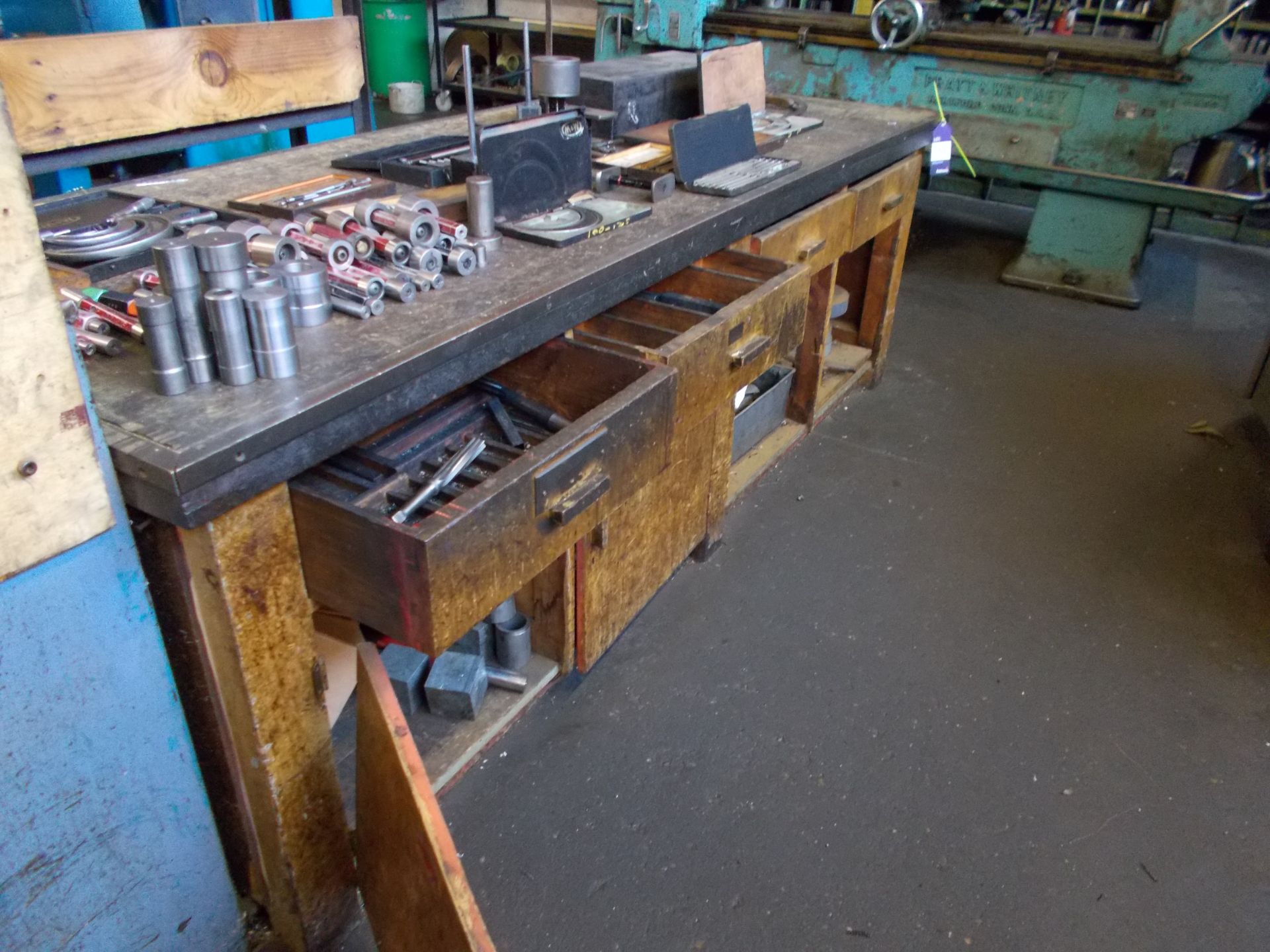 Workbench and contents including twist drills, reamers, grinding wheels, and rack and contents