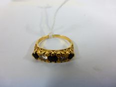 An 18ct Gold Diamond & Dark Stone Ring
