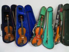 Four cased 1/2 size Violins