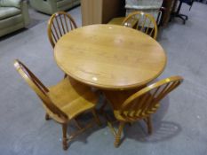 A Circular Dining Room Table and Four Chairs