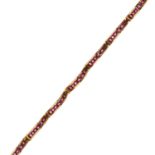 A VINTAGE RUBY LINE BRACELET in high carat yellow gold comprising a single row of eleven bevelled