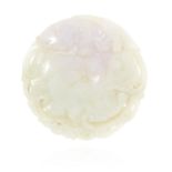 A CHINESE CARVED GREEN AND LAVENDER JADE DISC carved in detail to depict fish within scrolling