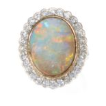 AN OPAL AND DIAMOND CLUSTER RING in platinum, set with a central cabochon opal, surrounded by