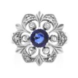 A SAPPHIRE AND DIAMOND RING in yellow gold and silver, the round cut sapphire of 0.85 carats
