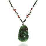 A JADEITE JADE PENDANT NECKLACE set with a carved jade plaque suspended from a woven necklace