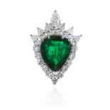 AN EMERALD AND DIAMOND CLUSTER PENDANT in platinum, set with a pear cut emerald (minor clarity