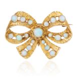 AN OPAL BOW BROOCH in yellow gold, the ribbon and bow motif jewelled with round cabochon opals, full