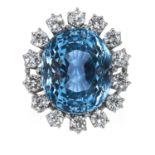AN AQUAMARINE AND DIAMOND RING in 18ct white gold, the oval cut aquamarine of 16.25 carats encircled